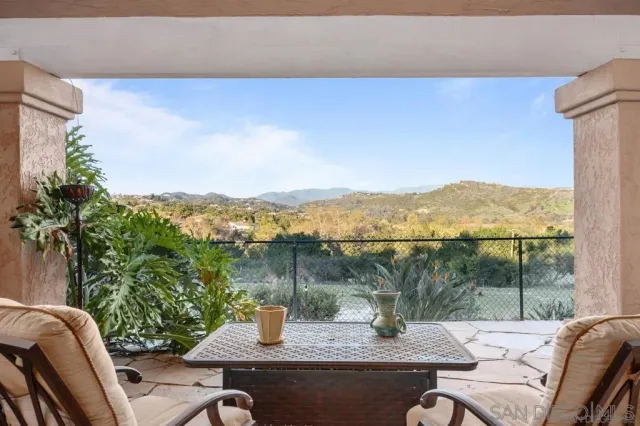 a view of a lake with couches in patio