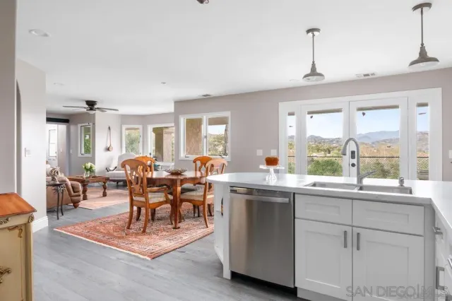 a view of a dining room and livingroom with furniture window and wooden floor