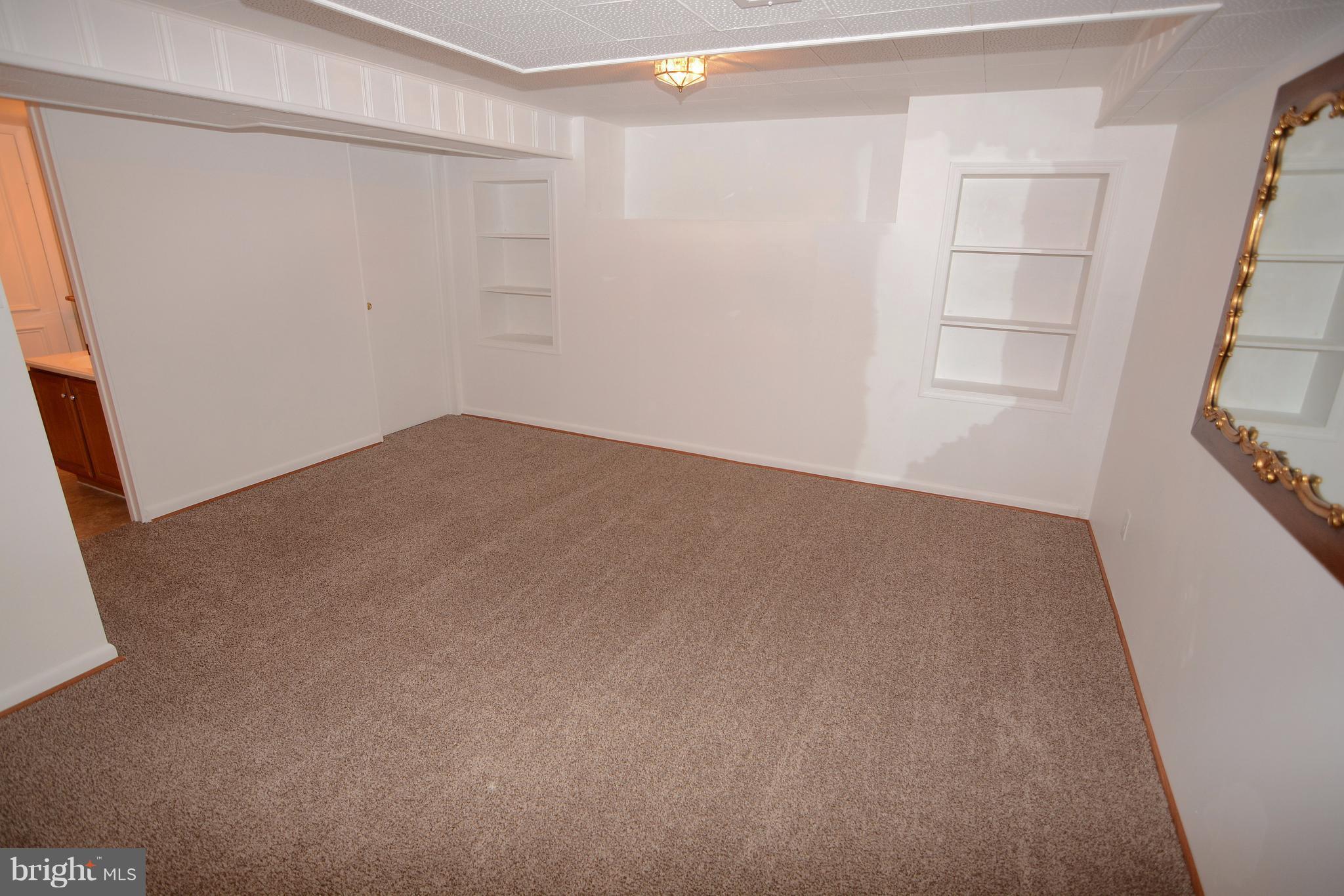 400 Ridgely Road Glen Burnie, MD 21061 - Photo 13 of 27 Lower level family room with built in shelves.
