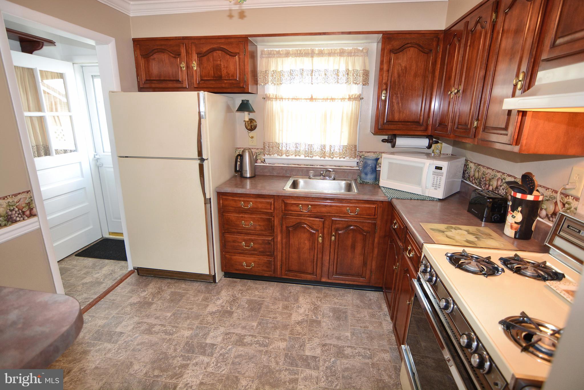 Cozy kitchen with beautiful cabinetry!