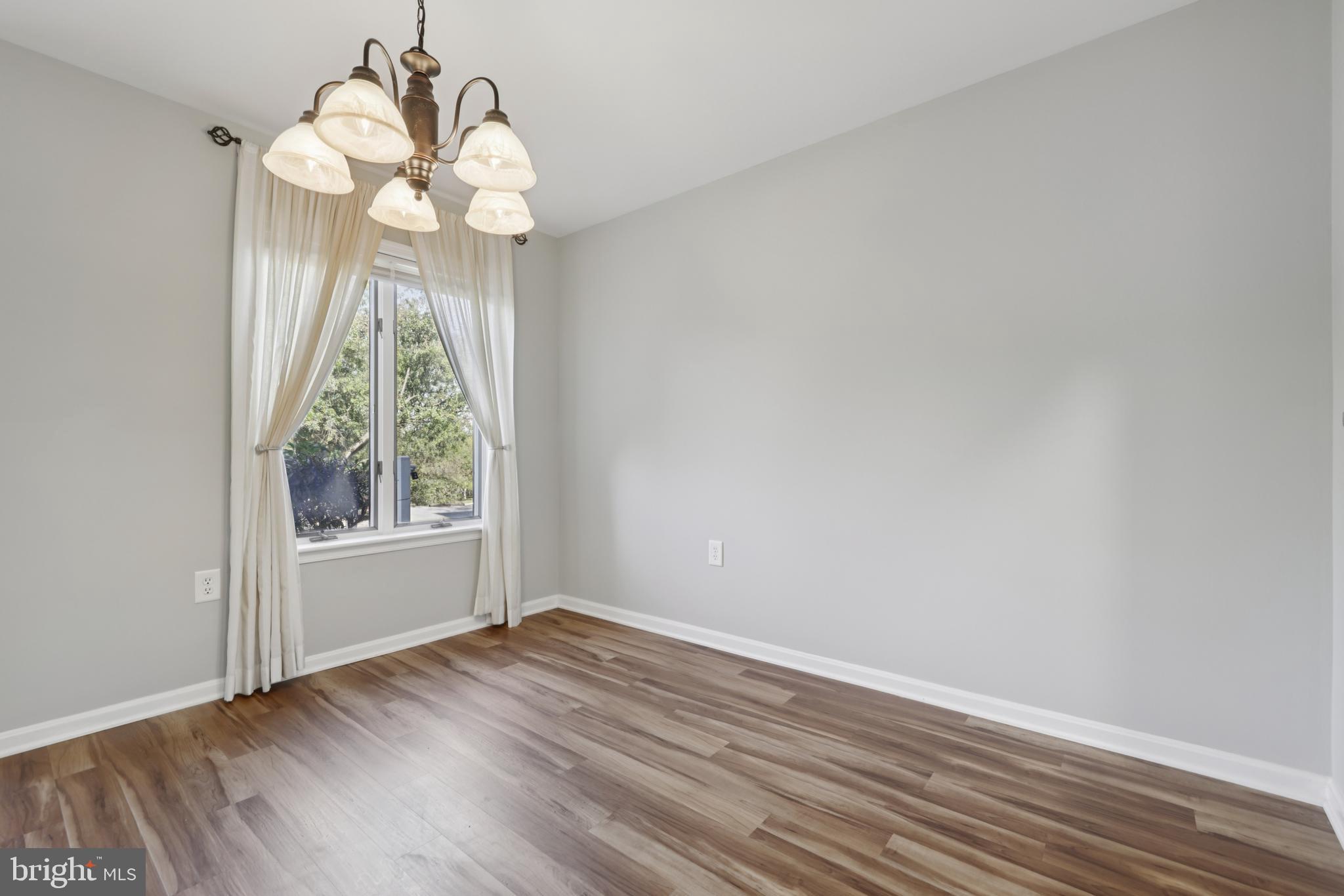 465 Pleasanton Road, Unit C14 Westminster, MD 21157 - Photo 12 of 39 wooden floor in an empty room with a window