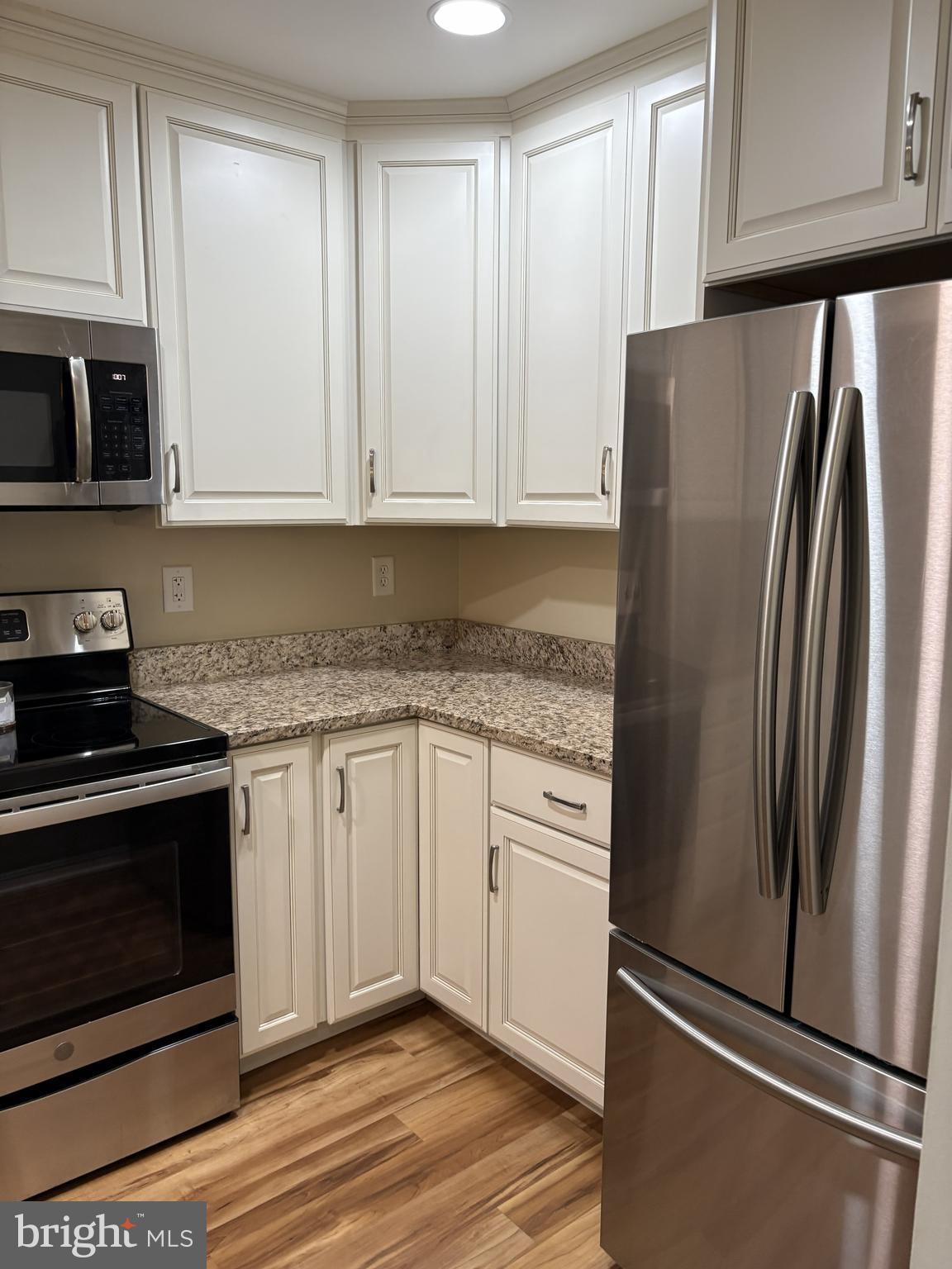 465 Pleasanton Road, Unit C14 Westminster, MD 21157 - Photo 18 of 39 a kitchen with stainless steel appliances granite countertop a refrigerator sink and cabinets