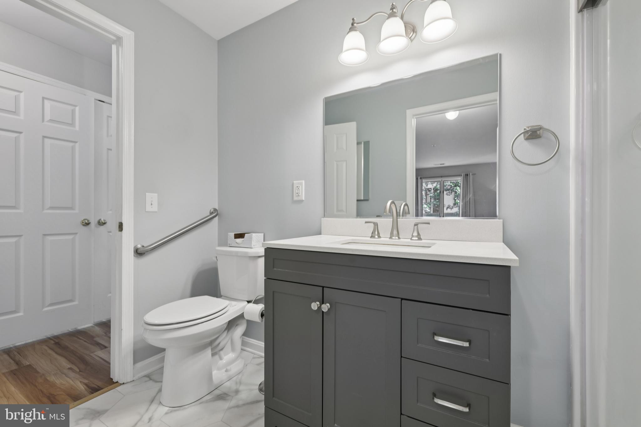 465 Pleasanton Road, Unit C14 Westminster, MD 21157 - Photo 20 of 39 a bathroom with a sink toilet and mirror