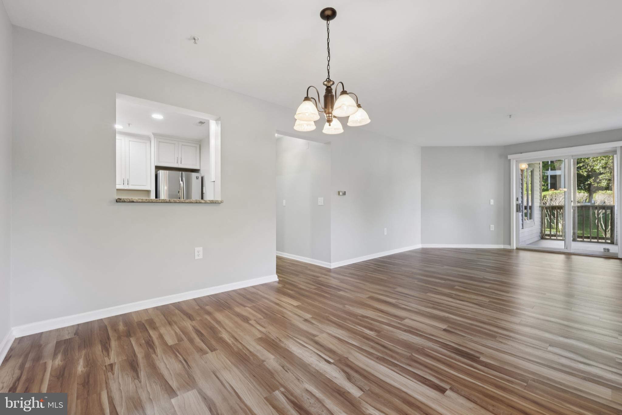 465 Pleasanton Road, Unit C14 Westminster, MD 21157 - Photo 8 of 39 a view of empty room with wooden floor and kitchen view