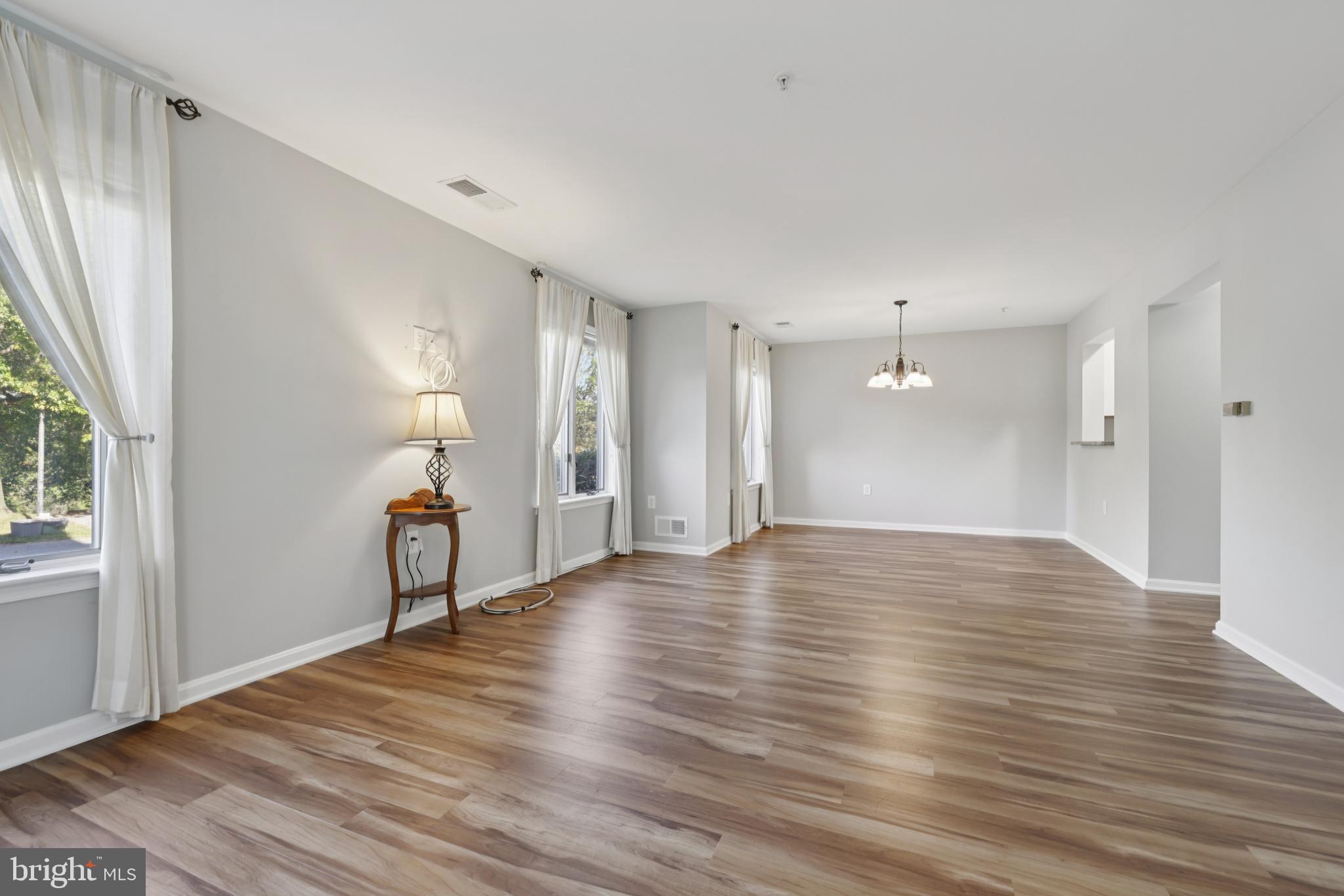 465 Pleasanton Road, Unit C14 Westminster, MD 21157 - Photo 10 of 39 a view of an empty room with wooden floor and a window