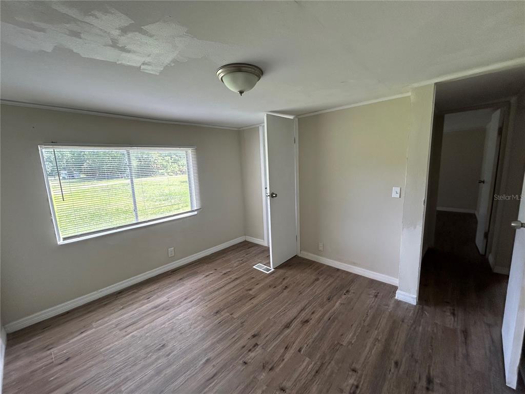 4265 North Beginning Path Crystal River, FL 34428 - Photo 11 of 18 a view of an empty room with wooden floor and a window
