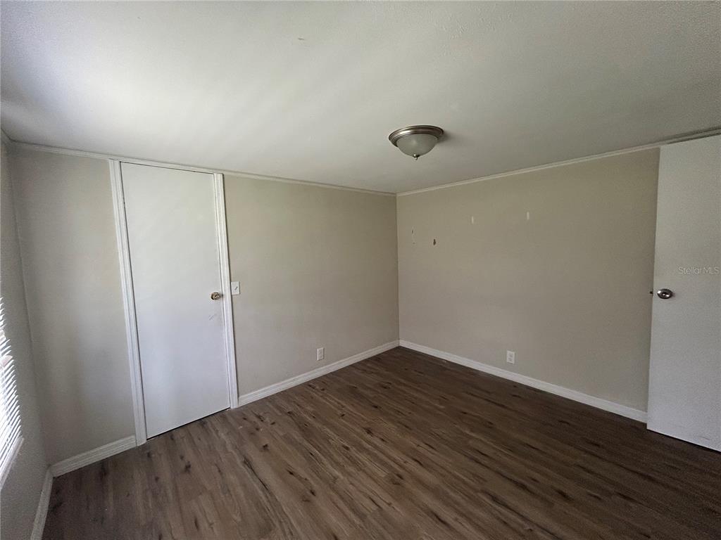 4265 North Beginning Path Crystal River, FL 34428 - Photo 13 of 18 a view of an empty room with wooden floor