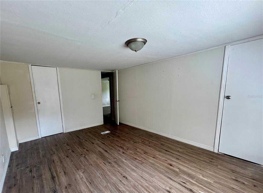 4265 North Beginning Path Crystal River, FL 34428 - Photo 15 of 18 a view of an empty room with wooden floor