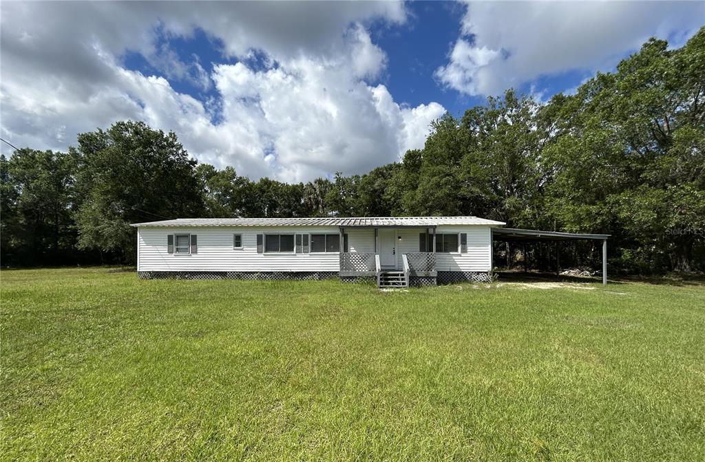 4265 North Beginning Path Crystal River, FL 34428 - Photo 18 of 18 a house with a garden in the background