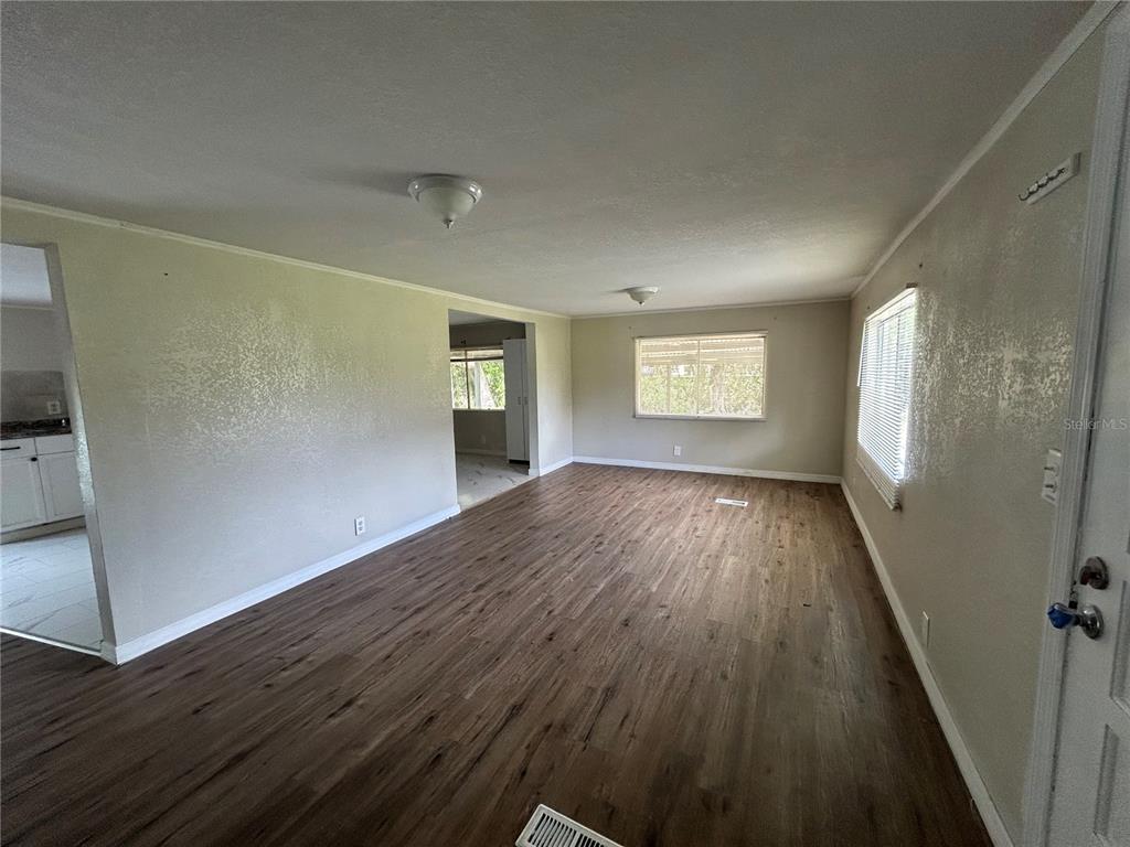 4265 North Beginning Path Crystal River, FL 34428 - Photo 3 of 18 wooden floor in an empty room with a window