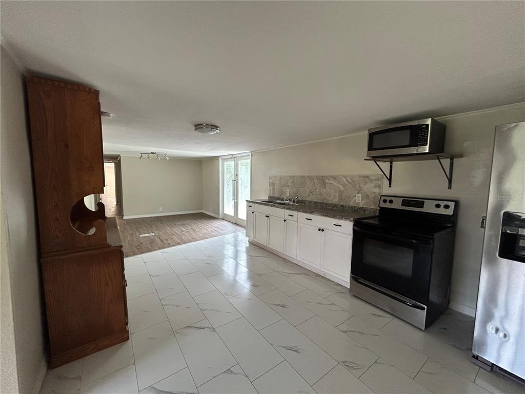 4265 North Beginning Path Crystal River, FL 34428 - Photo 5 of 18 a kitchen with stainless steel appliances granite countertop a refrigerator and a stove top oven