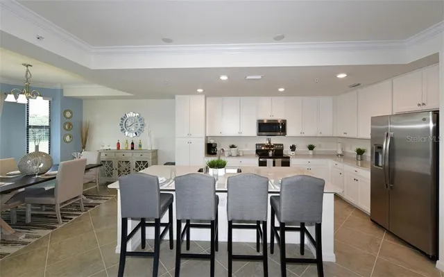 a kitchen with a stove a sink a microwave a counter top space and cabinets