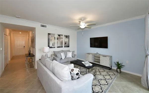 a living room with furniture couches and a flat screen tv