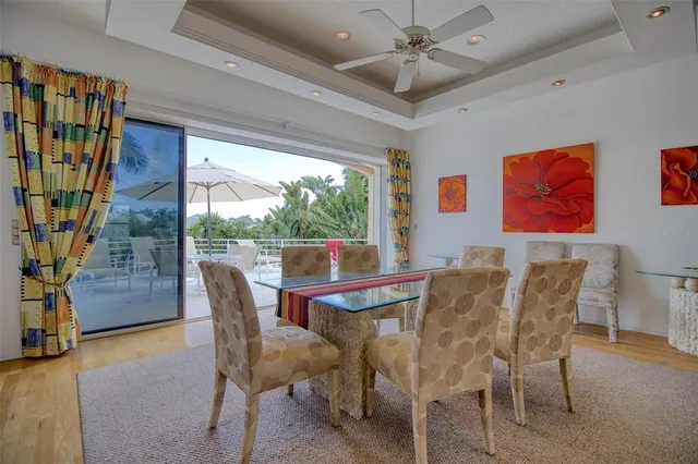a dining room with furniture and a floor to ceiling window
