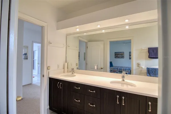 a bathroom with a double vanity sink and a mirror