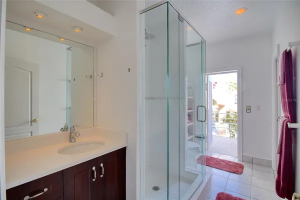 a bathroom with a sink vanity granite tub and shower