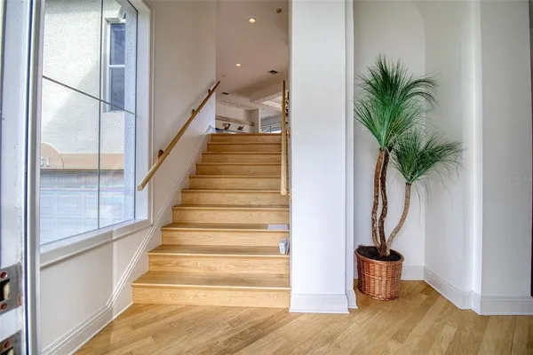 a view of entryway and hall with wooden floor