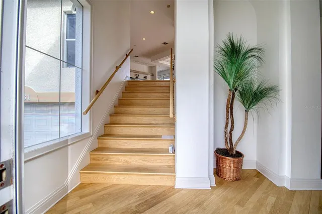 a view of entryway and hall with wooden floor