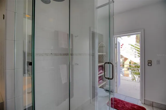 a view of a patio with a table and chairs under an umbrella