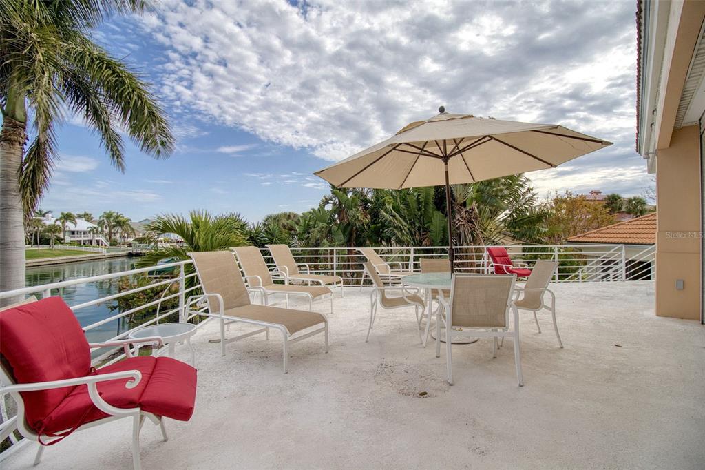 131 13th Street East Tierra Verde, FL 33715 - Photo 26 of 54 a view of a terrace with furniture