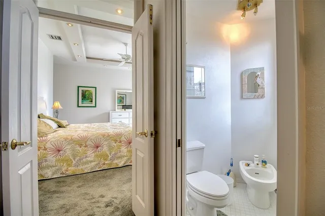 a bathroom with a bathtub a double vanity sink and a large mirror