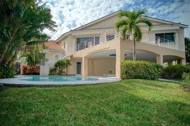 an aerial view of a house with a yard and sitting area
