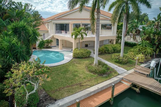 an aerial view of a house with a lake view