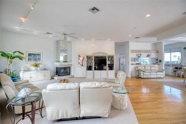 a living room with furniture and view of kitchen