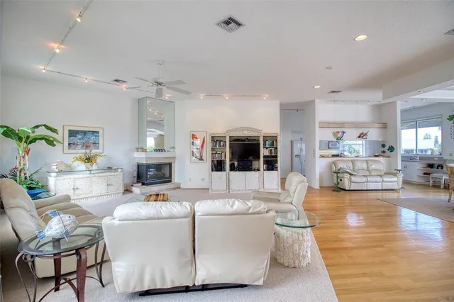 a living room with furniture and view of kitchen