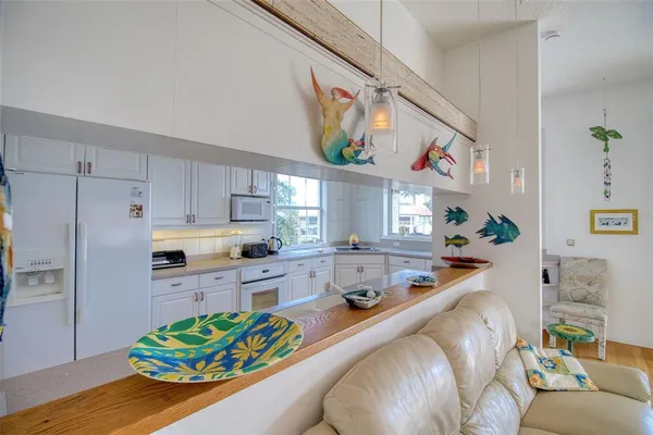 a kitchen with stainless steel appliances kitchen island granite countertop a refrigerator and a stove top oven