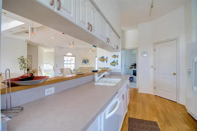 a large living room with stainless steel appliances kitchen island granite countertop furniture and a kitchen view