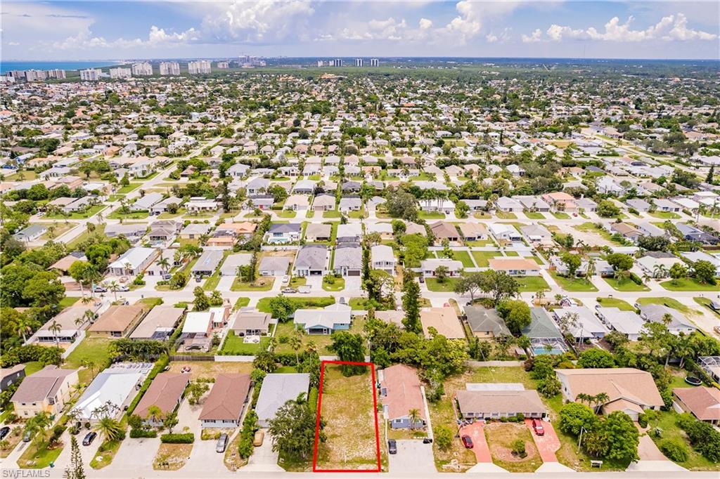 635 92nd Avenue North Naples, FL 34108 - Photo 2 of 6 View of urban area featuring property parcel outlined and nearby suburban area