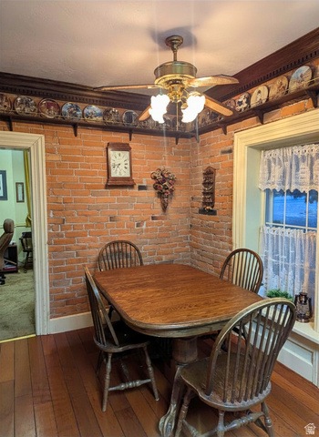 190 North 200 E Street Beaver, UT 84713 - Photo 10 of 40 Exposed brick wall with decorative wood trim, complemented by wood-finish flooring