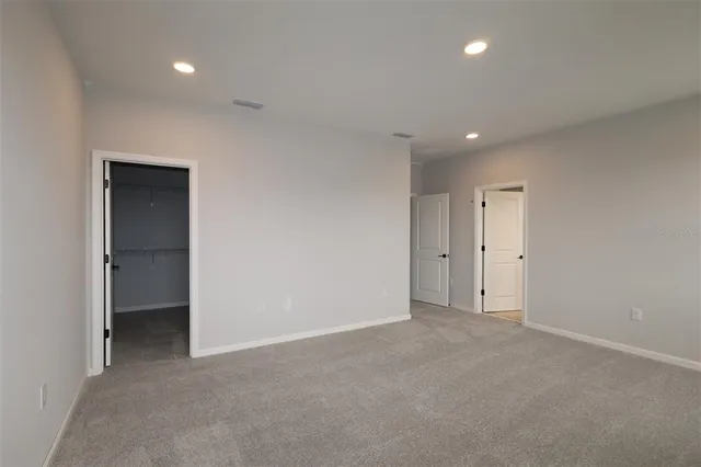 a view of an empty room and a bathroom