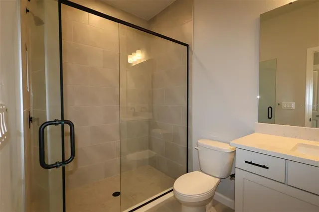 a bathroom with a shower a toilet and sink