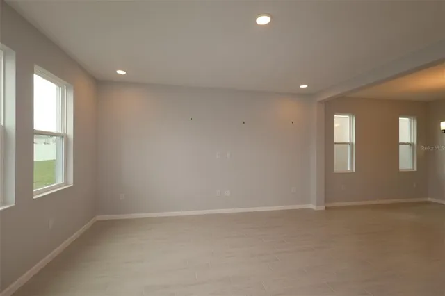 an empty room with windows and closet
