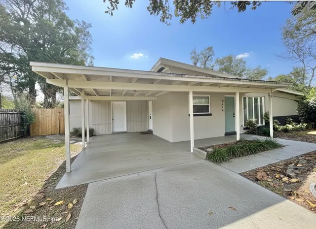 front view of a house with a yard and garage