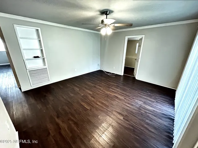 wooden floor in an empty room with a window