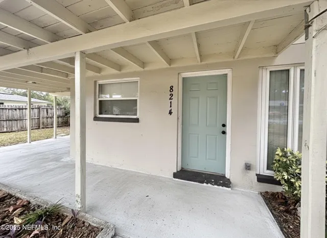 a bedroom with a bed and a potted plant