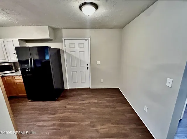 an empty room with wooden floor and closet