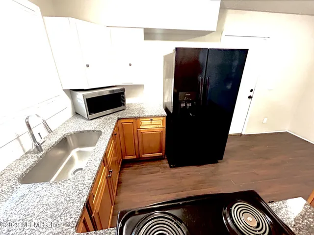 a kitchen with a refrigerator and a stove