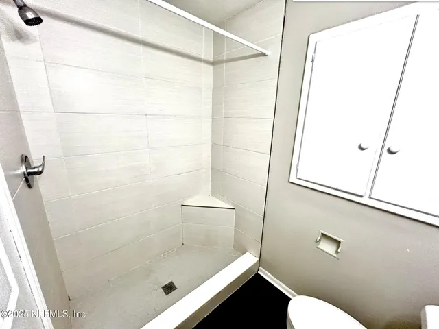 a bathroom with a shower and a toilet