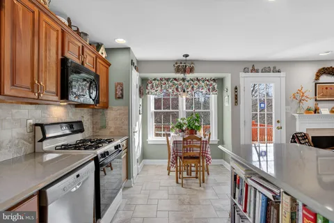 a kitchen with stainless steel appliances granite countertop a stove and a wooden cabinets