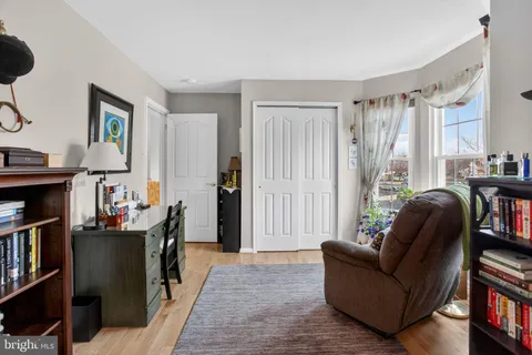 a living room with furniture and a book shelf