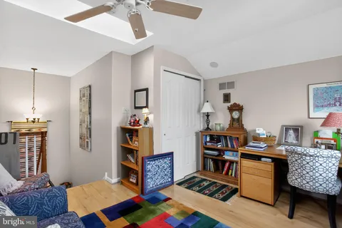 a living room with furniture and a bookshelf