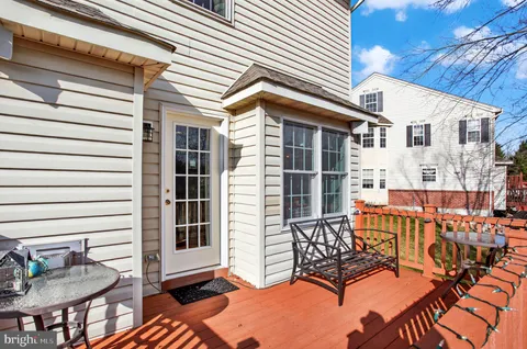 a view of a patio with a table and chairs and potted plants
