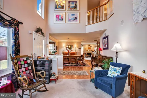 a living room with lots of furniture and a chandelier