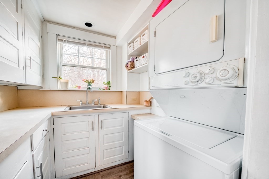 87 Conant Street Danvers, MA 01923 - Photo 13 of 31 a utility room with cabinets washer and dryer