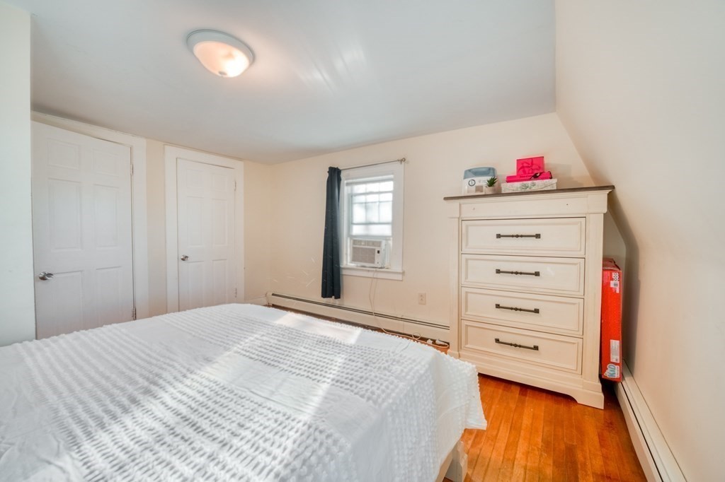 87 Conant Street Danvers, MA 01923 - Photo 15 of 31 a bedroom with a bed and cabinets