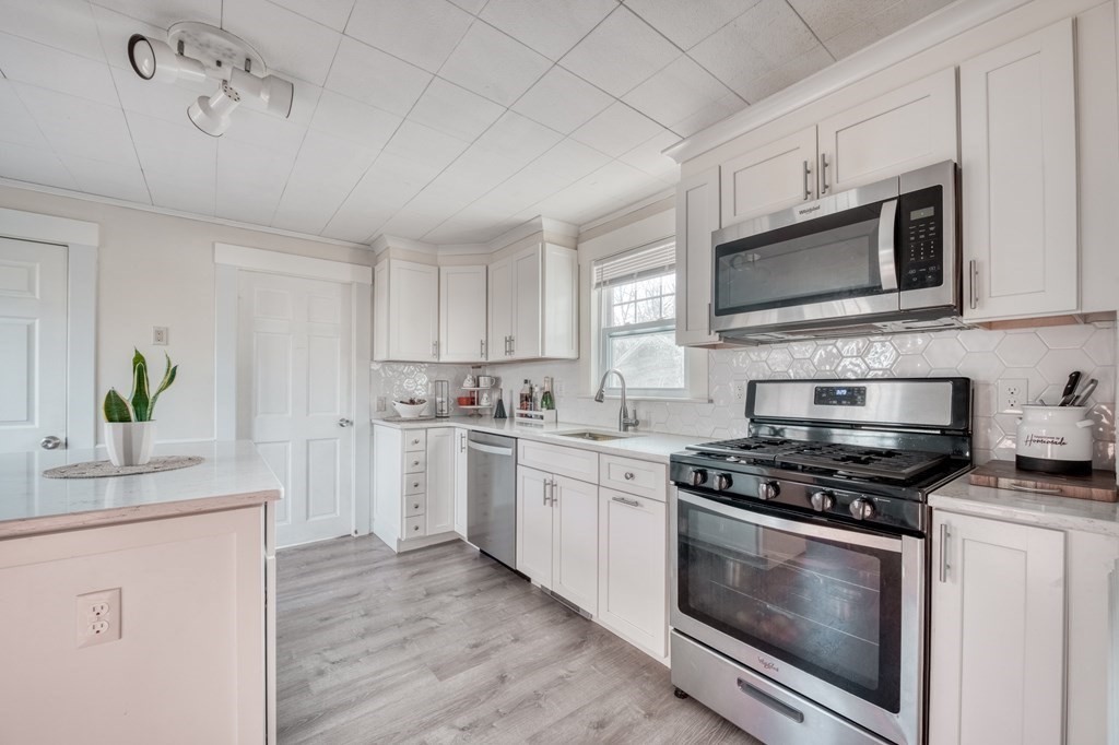 87 Conant Street Danvers, MA 01923 - Photo 2 of 31 a kitchen with cabinets stainless steel appliances and a sink